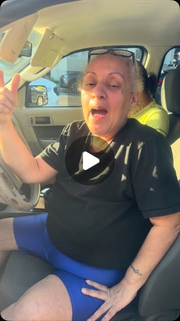Things just got better — customer giving thumbs up in her new car